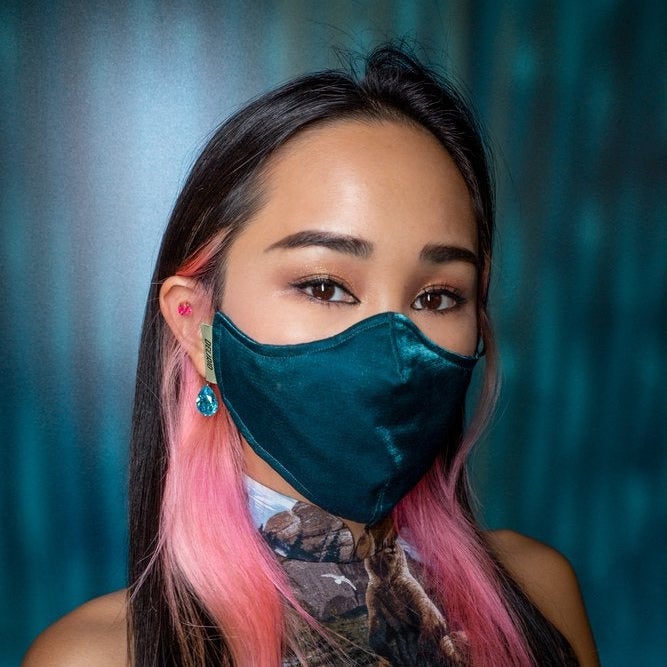 Harriet Lam, the founder of Delirio The Label, wearing a face mask from the Magnifico collection in the shade Emerald.